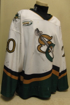 Brian Kerr #20 White 2000-01 Worn one season, 00-01 by Brian Kerr. This jersey is made by OT Sports. Great wear, altered length by host mom, shoulder patches, NOB and USHL crest.