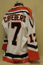 Omaha Lancers Mats Carsberg 1996-97 This gamer was worn by Mats Carsseberg uring the 96-97 season. "D" on right chest is a memorial for lost host parent. CCM logo and round USHL logo on rear hem, NOB. Shows great wear. Made by Bauer, size 52. 