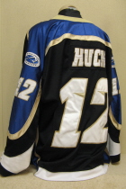 Kevin Huck Sioux Falls Stamepde 2003-04 #12 Worn during the 2002-03 USHL season. Shows great wear. Made by Gemini and is a size 54. NOB, shoulder patches, USHL & Gemini Crest on front. This style of jersey was worn for the first four seasons. 1999-2000 was Sioux Falls' first season in the league.