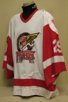 Thunder Bay Flyers Ken Ritson 98-99 white#29. This jersey was worn by first year goaltender Ken Ritson. Size Huge, sleevs cut midway down. Made by CCM this one has NNOB but is sponsored by Perellie's Cycle & Sport on the back. 
