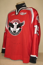 Waterloo BlackHawks #16 2001-02 Red This one was worn during the 2001-02 season by Zac Headrick. BlackHawk alternate logo patches on shoulders. Bauer and USHL logos on chest. This one has tons of wear as it was used for this and the previous season. Manufactured by SP, it is size 56. 