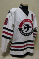 Waterloo Black Hawks White #16 Circa 1995. This is one of the old style Hawks jerseys. It is #16 and has NNOB rather a sponsor, The River City Athletic Center. It has the famous "Doves" on the shoulder and of course the original logo. Manufactured by Hooters Sportswear and is a size large. 
