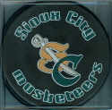 This style Musketeer souvenir puck available trough the team store during the 2000-02 seasons. Blank back.