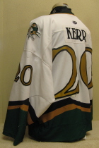 Brian Kerr #20 White 2000-01 Worn one season, 00-01 by Brian Kerr. This jersey is made by OT Sports. Great wear, altered length by host mom, shoulder patches, NOB and USHL crest.