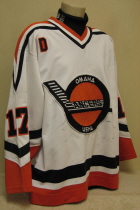 Omaha Lancers Mats Carsberg 1996-97 This gamer was worn by Mats Carsseberg uring the 96-97 season. "D" on right chest is a memorial for lost host parent. CCM logo and round USHL logo on rear hem, NOB. Shows great wear. Made by Bauer, size 52. 
