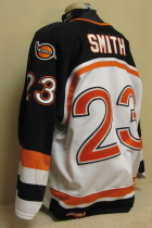 Omaha Lancers Trevor Smith 04-05 #23 This white gamer was worn by Trevor Smith. Trevor lead the Lancers in scoring this season. Lancer old logo patches on shoulder, USHL and CCM Tagging on rear hem, NOB. Aternate captain "A". Shows nice overall wear. Made by CCM, size 56.