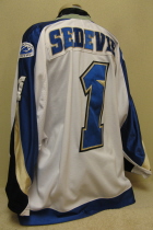 Layne Sedevie 2001-02 Sioux Falls Stampede #1 This jersey was worn by goaltender Layne Sedevie during the 2001-02 season. Shows great wear. Mfg. by Gemini. NOB, shoulder patches, USHL & Gemini crest on front of jersey. This style of jersey was worn for the first four seasons. 1999-2000 was Sioux Falls' first season in the league. 