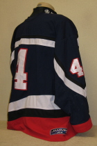 USHL All Star Jersey worn Two NHLer's. This is a home USHL All-star jersey number #4. These were also the jerseys the USHL team wore while representing the USA in the annual 4 Nations Tournament. Worn for two seasons, 99-00 and 00-01, the first season it was worn by now New Jersey Devil David Hale in both his first USHL All-Star game and during the 4 Nations Tournament. The second season it was worn by Tampa Bay draft pick Art Femenella during the USHL All-Star game. It is made by Jamin