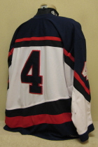 USHL All Star Jersey worn Two NHLer's. This is a home USHL All-star jersey number #4. These were also the jerseys the USHL team wore while representing the USA in the annual 4 Nations Tournament. Worn for two seasons, 99-00 and 00-01, the first season it was worn by now New Jersey Devil David Hale in both his first USHL All-Star game and during the 4 Nations Tournament. The second season it was worn by Tampa Bay draft pick Art Femenella during the USHL All-Star game. It is made by Jamin