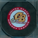 2004-05 Official game Puck Green Bay Gamblers. These were was available at the start of the 04-05 season and were sold through some of the team stores or directly from the League supplier, OGP Enterprises. Shown are both versions. Each puck also has the official USHL logo on the reverse.